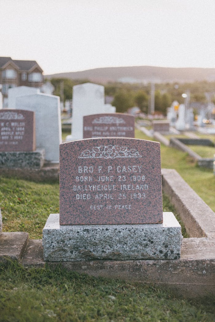 A tranquil cemetery scene featuring historic gravestones under a soft sunset glow, capturing a sense of peace.